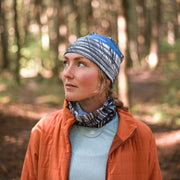 Young woman enjoying a walk in the woods wearing the new Expressive Sketch Beanie from Elise Charette with assorted tube, from AW25-26 Lalita's Art Shop collection.