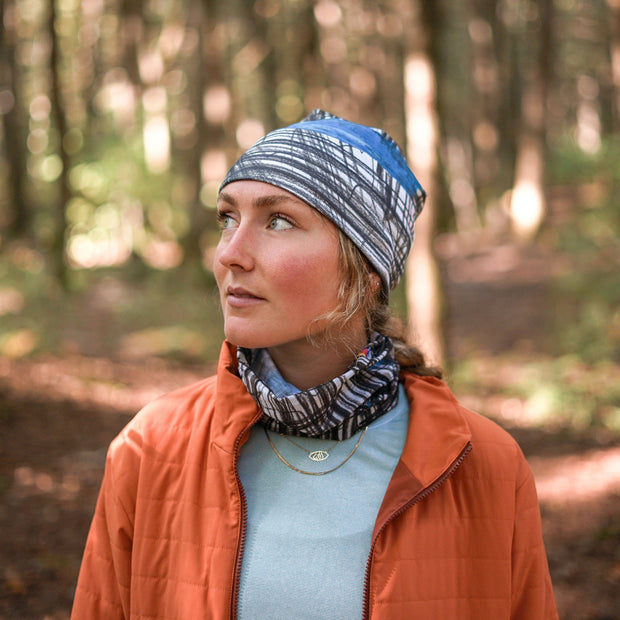 Young woman enjoying a walk in the woods wearing the new Expressive Sketch Beanie from Elise Charette with assorted tube, from AW25-26 Lalita's Art Shop collection.