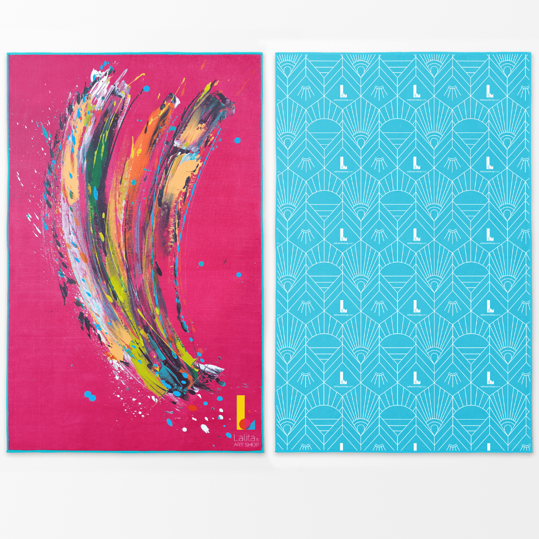 Oversized pink beach towel with abstract multicolor brushstrokes on one side and a geometric aqua pattern on the other.