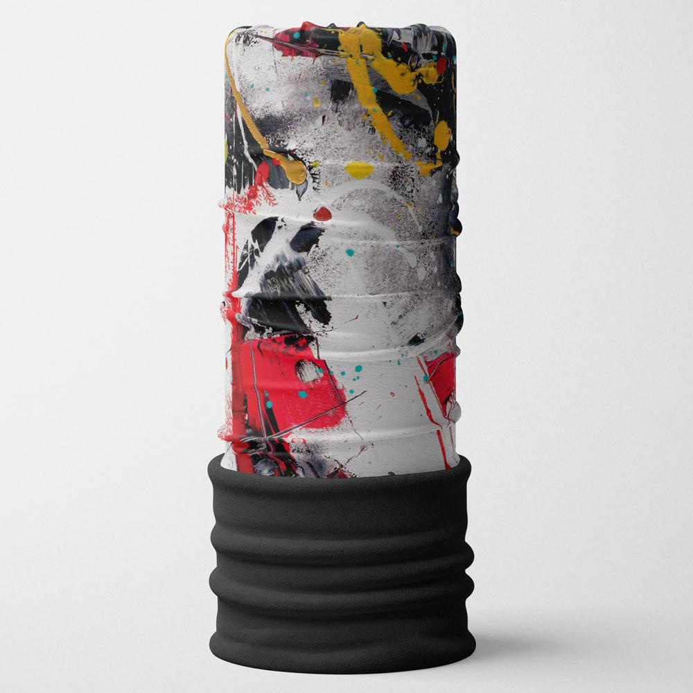Un tube debout avec un motif d'art abstrait vibrant rouge, noir, jaune et blanc, surmonté d'un revers côtelé noir.