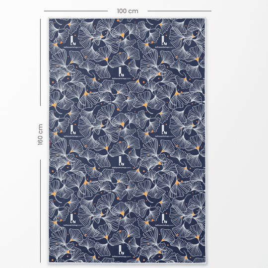 The Spring Reversible Microfiber Premium Towel laid flat, showing its full 160cm x 100cm dimensions with a navy ginkgo leaf pattern.