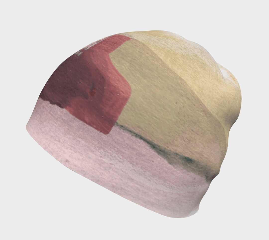 Vue latérale de la tuque "Le Nomade Artistique", soulignant le motif abstrait avec des nuances de jaune et de rose.