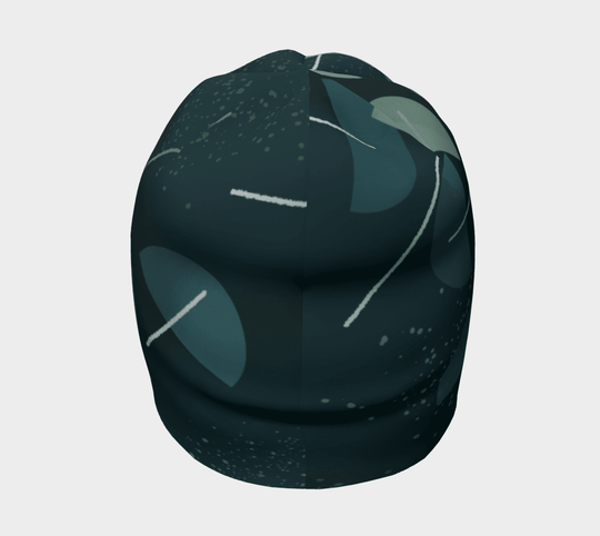 Vue latérale de la tuque à motif abstrait bleu sarcelle, soulignant sa couronne arrondie et son design.