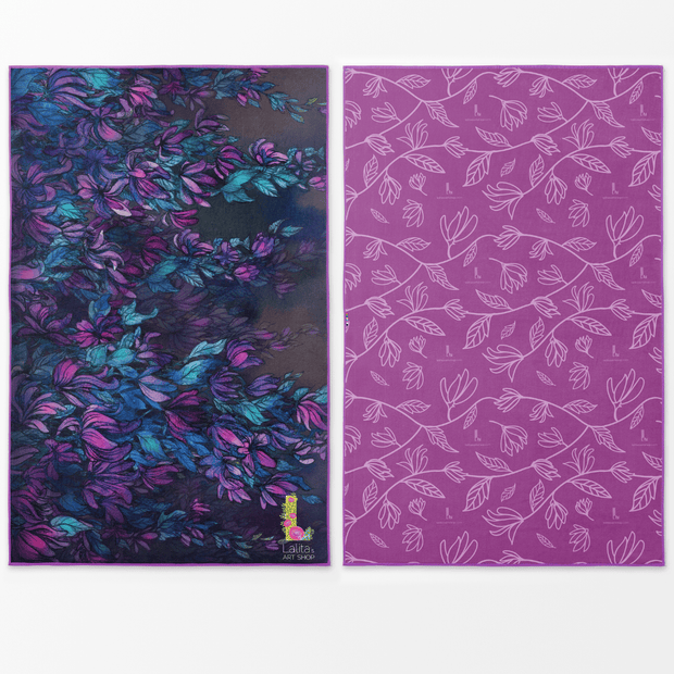 Wisteria x-large outdooring towel feature a side with an illustration of blue, aqua and purple wistera flowers, designed by artist Claire Aghinolfi and the reversible side is a modern and purple leaves design.