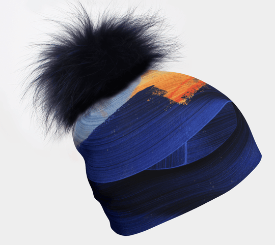 Yellow &amp; Blue Beanie with removable navy fur pom, showcasing abstract brushstroke art.