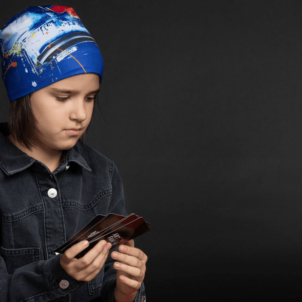 Girl wearing the beautiful blue abstract beanie hat for adults and kids