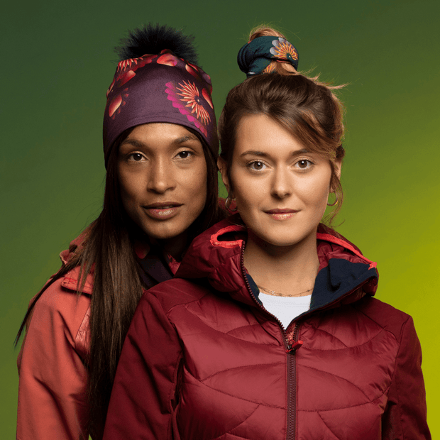 Woman wearing the Sunflower Read Beanie with Black Pompom from Zaire with the friend wearing the Sunflower Green Tube as hair Scrunchie. Lalita's Art Shop 24 Collection